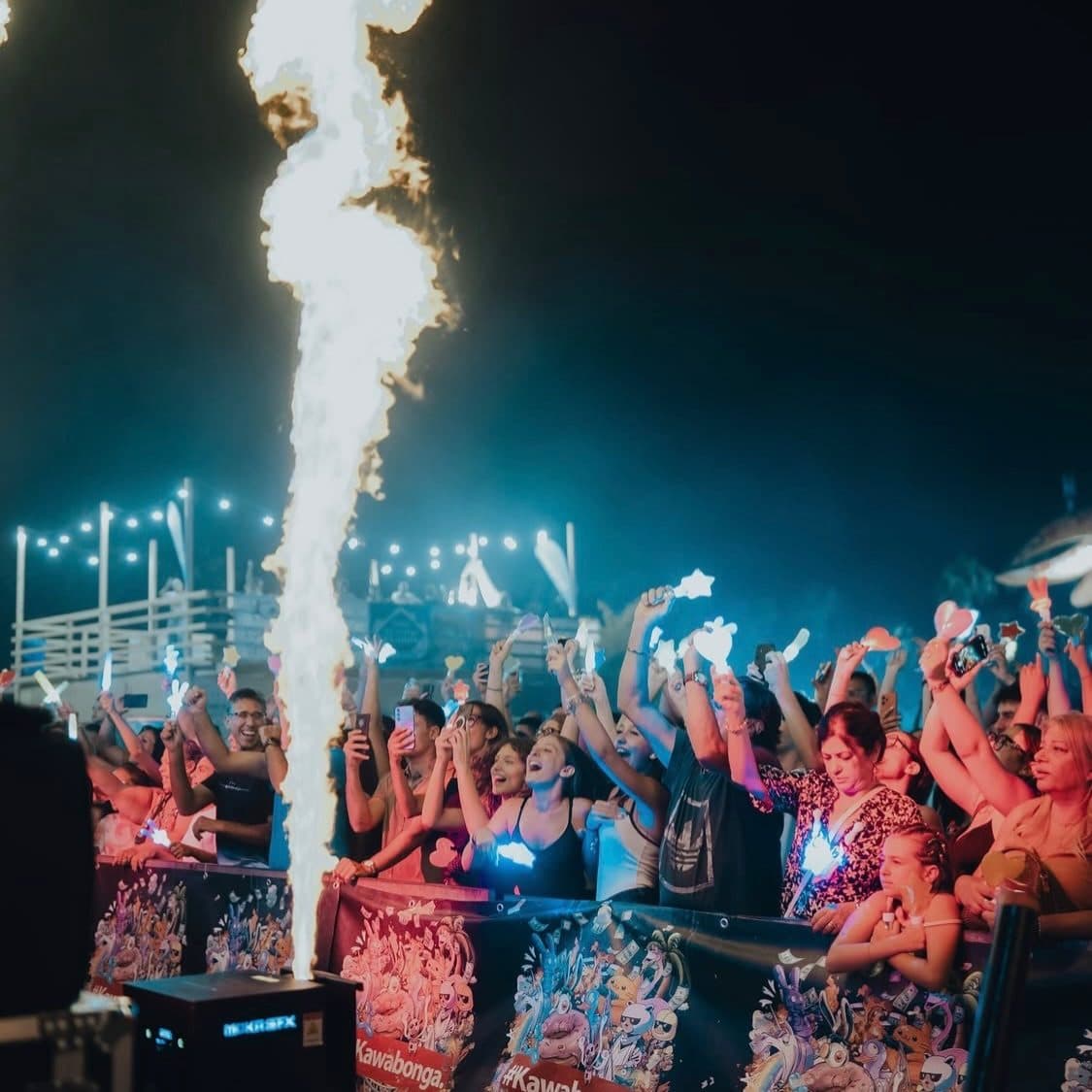 A column of fire above the crowd at night