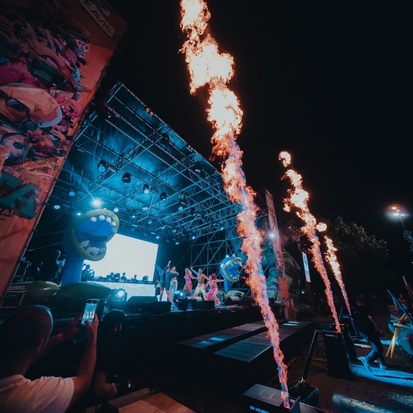 Flames at the sides of a blue stage with LED wall