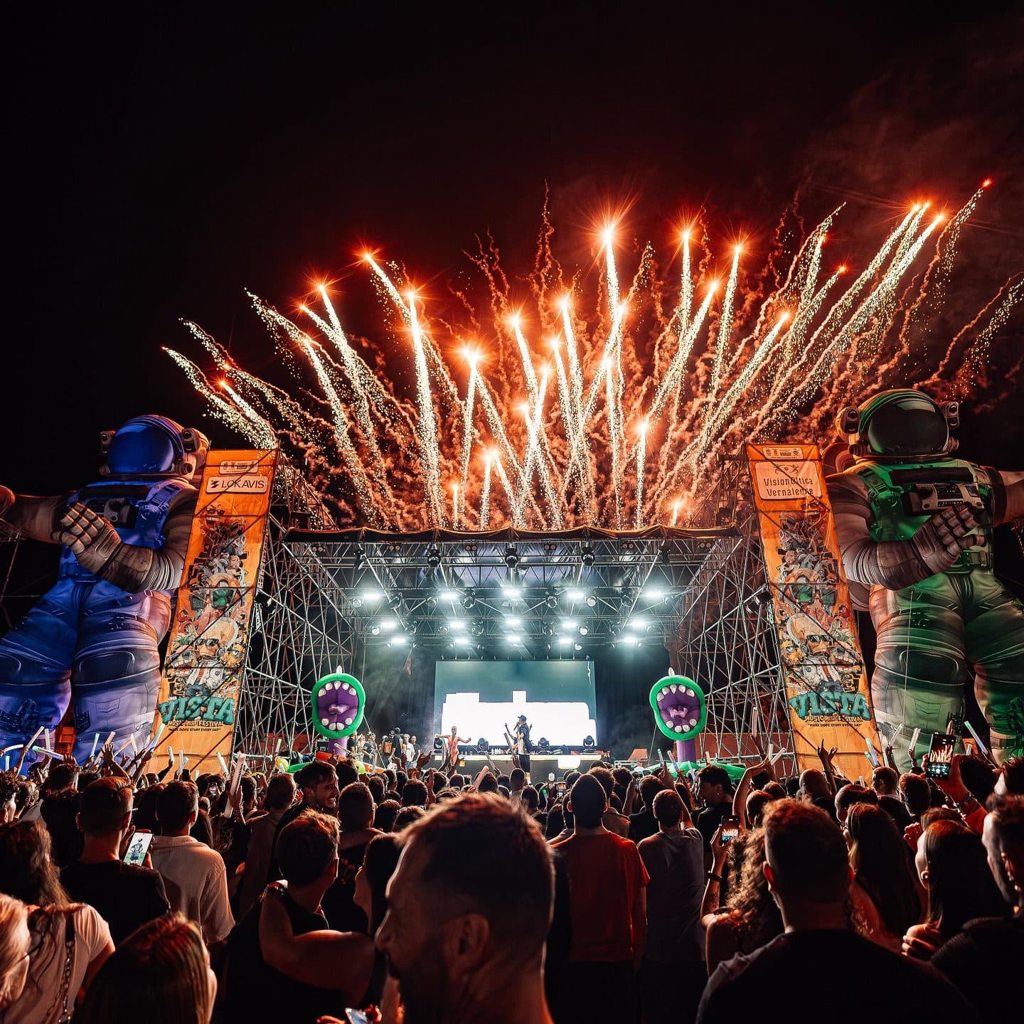 Pyrotechnics and LED wall in a packed town square