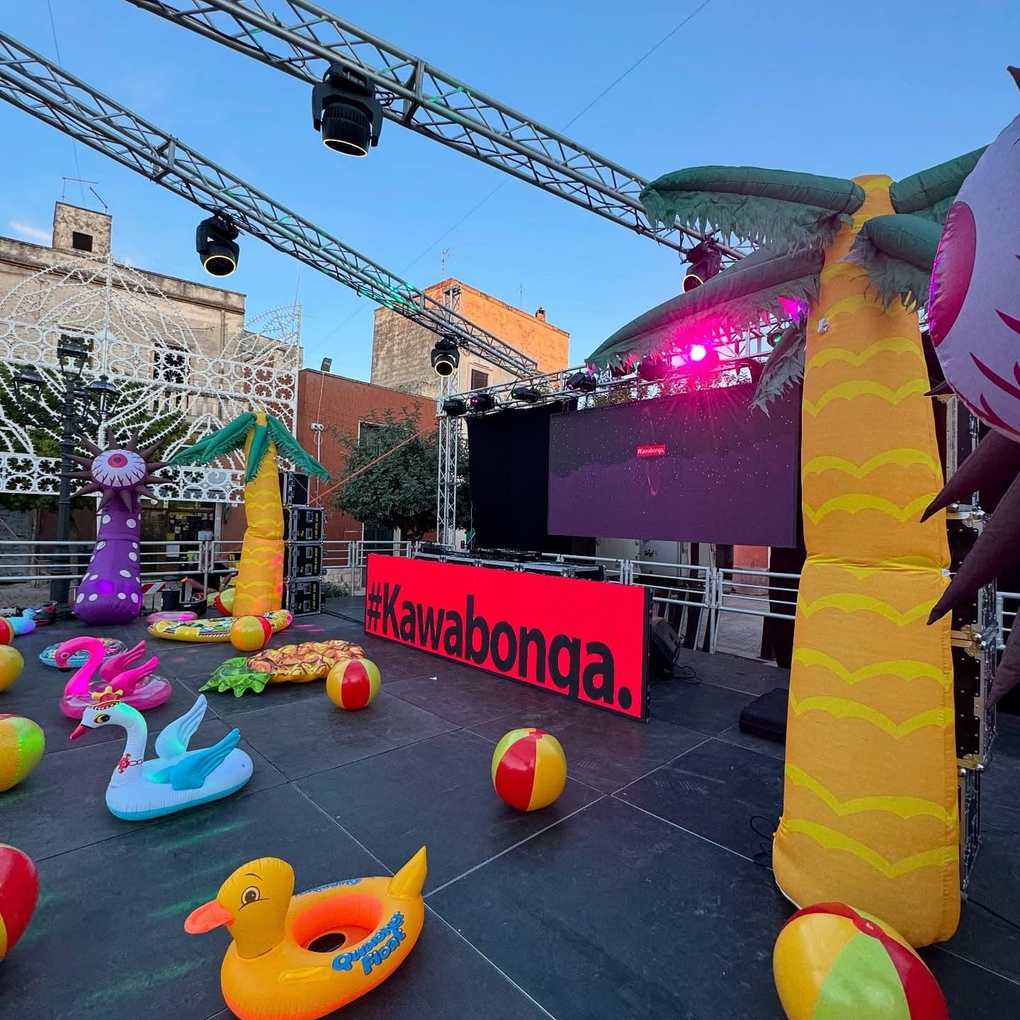 A pool event with truss, LED wall and inflatables